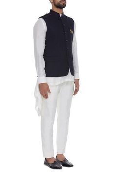 Style your traditional ensemble with this classic black bundi accentuating embroidered horse crest and shoulder epolets for a dapper look.
Sleeveless
Mandarin collar
Slit pocket
Button down placket - Aza Fashions Nehru Jacket For Men, Embroidered Horse, Nehru Jacket, Nehru Jackets, Jacket For Men, Jackets Online, Mandarin Collar, Flared Sleeves, Aza Fashion