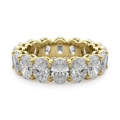 a yellow gold ring with five round cut diamonds on the side and two rows of smaller stones