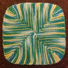 a crocheted dishcloth is sitting on the floor