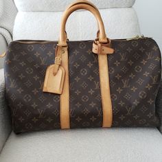 Louis Vuitton Keepall 45 *Purchased Pre-Loved And Only Used A Handful Of Times. *Vintage Lv Keepall 45 Made In 1998. *Perfect For A Carry-On Travel Bag On The Plane Or A Weekend Getaway. *Interior Is Very Clean With No Stains. *Exterior Is In Very Good Condition For It's Age. No Cracking. *Hardware Is In Good Condition, Very Minor Scratches *Light Water Marks On The Vachetta. *Comes With Lock And Keys. Please Review Photos And Let Me Know If You Have Any Questions. Lv Keepall, Louis Vuitton Keepall 45, Keepall 45, On The Plane, Water Marks, Light Water, Louis Vuitton Keepall, Lock And Key, Water Lighting