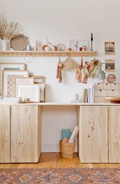 a room with wooden shelves and pictures on the wall, rugs and other items