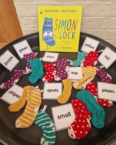 there are many socks that are on the plate with name tags in front of them