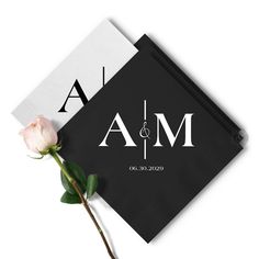 a single rose sitting on top of a black and white napkin with the word ma