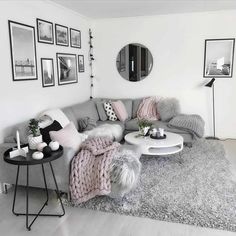 a living room filled with lots of furniture and pictures on the wall above it's coffee table