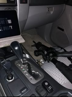 the inside of a car with an electronic device in it's center console and steering wheel