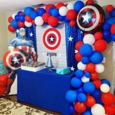 the balloon arch is decorated with red, white and blue balloons for an avengers themed birthday party