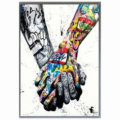 two people holding hands with graffiti all over their body and arms, both covered in multicolored paint