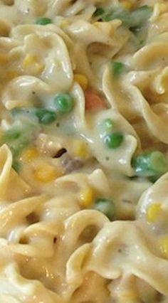 a bowl filled with pasta and peas on top of a table