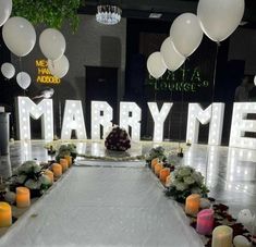 a table with candles and flowers on it in front of a large marquee