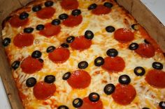 a pizza with pepperoni and olives in a box