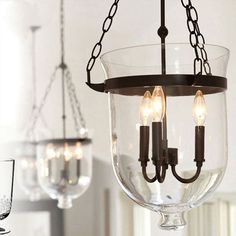 Introduce a touch of vintage-inspired charm to your living space with the Birdun Industrial 3-Light Suspension Chandelier. Crafted with meticulous attention to detail, this exquisite fixture boasts a clear glass urn shade that beautifully showcases the three bulbs within. The industrial design, featuring a sleek metal frame finished in an elegant black, complements a variety of interior styles, from modern lofts to rustic farmhouses. With its adjustable height, this chandelier can be customized to fit any room perfectly. Whether illuminating your dining room, chen, or foyer, the Birdun Suspension Chandelier effortlessly adds a warm and inviting ambiance, creating a focal point that will captivate your guests for years to come.Size: 10 to 14 Inch Fixture Width: 12" Chain/cord Length: 31.5" Ceiling Lamp Dining Room, Industrial Hanging Lights, Metal Living Room, Dining Room Industrial, Dining Room Ceiling, Lantern Chandelier, Metal Pendant Light, Kitchen Lighting Fixtures, 3 Light Pendant