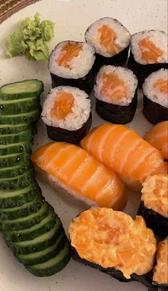 sushi and cucumber arranged on a white plate