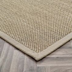 an area rug on the floor that is made out of wood and woven in beige