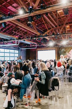 a large group of people are sitting in chairs