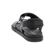 Ferragamo's Black 'Day' Double Strap Sandals. These sandals, inspired by sports aesthetics, boast a luxurious oiled calfskin upper that radiates elegance. Featuring a broad strap across the toes and a Velcro ankle strap adorned with a distinctive logo, these sandals seamlessly combine practicality with sophisticated, modern design. The insole is enveloped in textured leather, enhancing both comfort and lavish appeal. Additionally, the custom chunky rubber sole showcases a 3D signature at the bac Sports Aesthetics, Double Strap Sandals, Makeup Travel Case, Plastic Pollution, Logo A, Sandals For Sale, Travel Makeup, Beauty Accessories, Travel Case