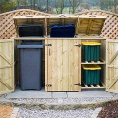 an outdoor storage area with trash cans and bins