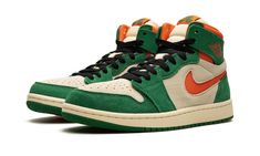 The Air Jordan 1 High Zoom CMFT 2 "Pine Green" is a colorway of the modified version of the retro basketball shoe with green and orange details.  The Jordan 1 Zoom Comfort 2 is the second version of the Jordan 1 Zoom Comfort shoe that puts a casual, more comofrtable spin on the classic silhouette.  The “Pine Green” features a Muslin suede base with Pine Green suede overlays.  An Orange Blaze cut-out Swoosh appears on the sides and a “Wings” logo is found on the collar.  “Zoom Air” branding repla Pine Green Outfit, High Top Nikes, Orange Nike Shoes, Green Jordans, Orange Details, Retro Basketball Shoes, Retro Basketball, Comfort Shoe, Orange Shoes