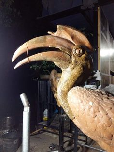 a large bird statue sitting on top of a table