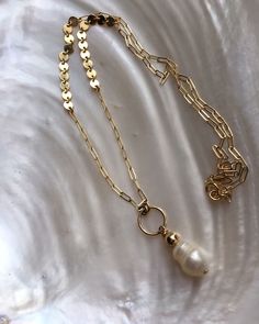 "A large baroque freshwater pearl pendant on a unique gold filled thick paperclip chain. A statement necklace that's elegant and edgy at the same time. All elements are very high quality 14kt gold filled and genuine pearl. Pearls will differ in shape and inclusions due to the raw nature of each, making each necklace unique to its owner. Measures 18\" with a 2\" extension. Pictures are with the longest length. ---------------------------------------------------------------------------- >> C Minimalist Gold Pearl Necklace With Paperclip Chain, Gold Baroque Pearl Chain Necklace Gift, Gold Necklace With Baroque Pearl And Paperclip Chain, Gold Pearl Necklace With Paperclip Chain, Baroque Pearl Paperclip Chain Jewelry Gift, Gold Pearl Necklace, Etsy Fashion, Gold Pearl, Unique Necklaces