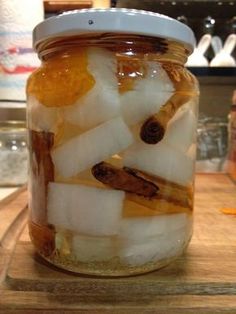 a jar filled with lots of food on top of a wooden table