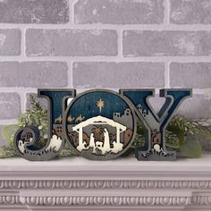 the word joy is displayed on top of a mantle