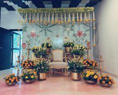 a decorated stage with chairs and flowers on the floor