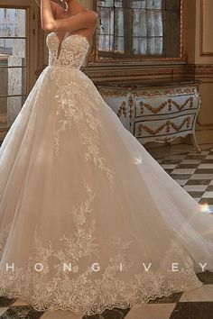 a woman in a wedding dress is taking a selfie with her cell phone while posing for the camera