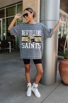 Make a statement in any crowd with our New Orleans Saints oversized fit, all-over mini rhinestone short sleeve tee featuring a ribbed neckline. Embrace the sparkle while staying comfortable—perfect for every dedicated fan. Ny Giants, Los Angeles Chargers, Tennessee Titans, Los Angeles Rams, New Orleans Saints, Indianapolis Colts, New York Jets, Ribbed Neckline, San Francisco 49ers