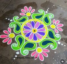 a colorful flower design is on the ground