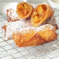 three pastries on a cooling rack with powdered sugar