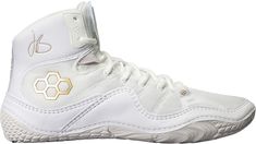 the nike air jordan basketball shoe is white and has gold accents on the upper part