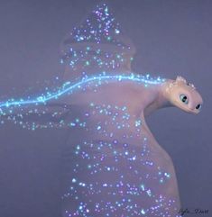 a white dragon with blue lights on it's wings