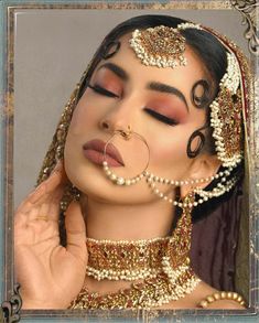 a woman with makeup and jewelry on her face