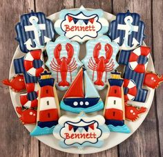 decorated cookies are arranged on a plate with the name bennet in red, white and blue