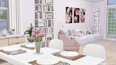 a living room filled with furniture and a white dining table surrounded by pink tulips