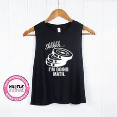 Add humor to your workouts with our 'Shh I'm Doing Math' weightlifting tank tops and gym shirts. Lift in style with these funny tees, perfect for powerlifting and a fun addition to your workout tank collection. ---------------------------------------------------------- 𝐌𝐨𝐫𝐞 𝐜𝐨𝐥𝐨𝐫 & 𝐒𝐡𝐢𝐫𝐭 𝐨𝐩𝐭𝐢𝐨𝐧𝐬 ➤ https://www.etsy.com/shop/HustleVogue 𝐍𝐎𝐓𝐄: Prior to placing your order, please verify the color availability for each shirt type displayed on the listing image. -------------- Black Gym Tops With Funny Text, Black Gym Top With Funny Text, Funny Crossfit Shirts, Weight Lifting Humor, Powerlifting Shirts, Crossfit Shirts, Add Humor, Funny Gym Shirts, Gym Gifts