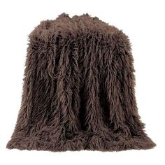 a brown furry animal blanket sitting on top of a white floor