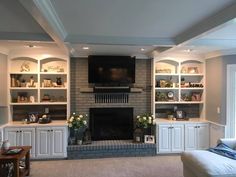 a living room filled with furniture and a flat screen tv mounted on the wall above a fireplace