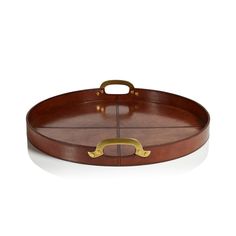 an oval wooden tray with brass handles and handles on the bottom, sitting on a white surface