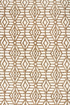 a close up view of an intricate pattern on a wallpapered surface in white and beige