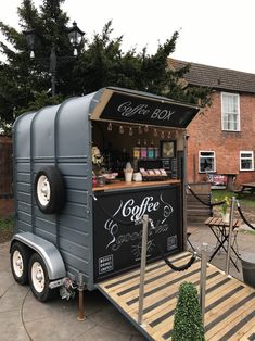 a small food cart with coffee on the side