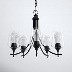 a black chandelier with five clear glass shades