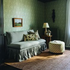 a living room with green walls and furniture