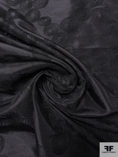 a black fabric with an intricate design on the bottom and side, it is very soft