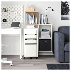 a room with a chair, desk and bookshelf