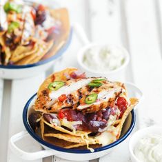 two plates with nachos and salsa on them