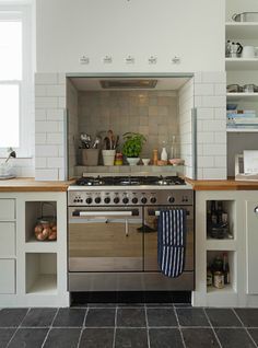 a kitchen with an oven, stove and cabinets