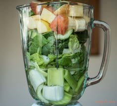 a blender filled with lots of fresh vegetables