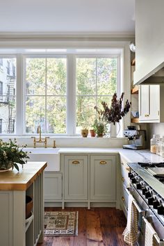 a kitchen filled with lots of counter top space next to a stove top oven and sink