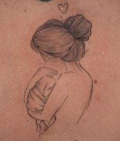 the back of a woman's shoulder with a drawing of a girl hugging her arm